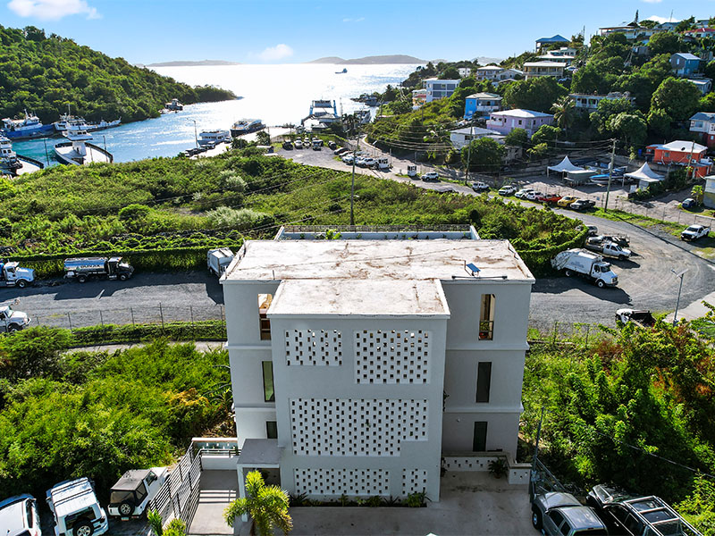 THE ALMA - ST JOHN building with distinctive perforated facade overlooking the harbor