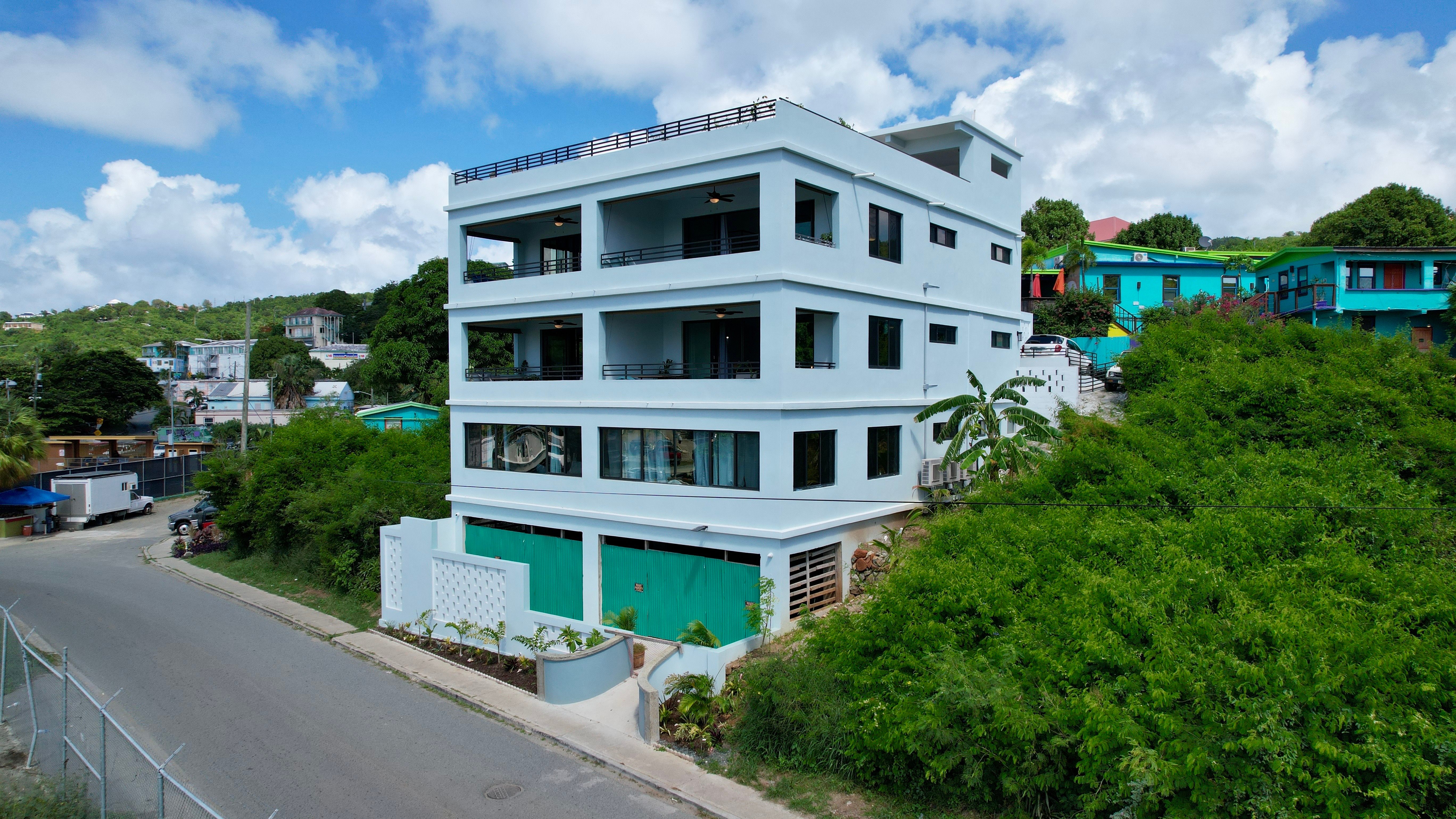 The Alma exterior view - modern white building with turquoise accents