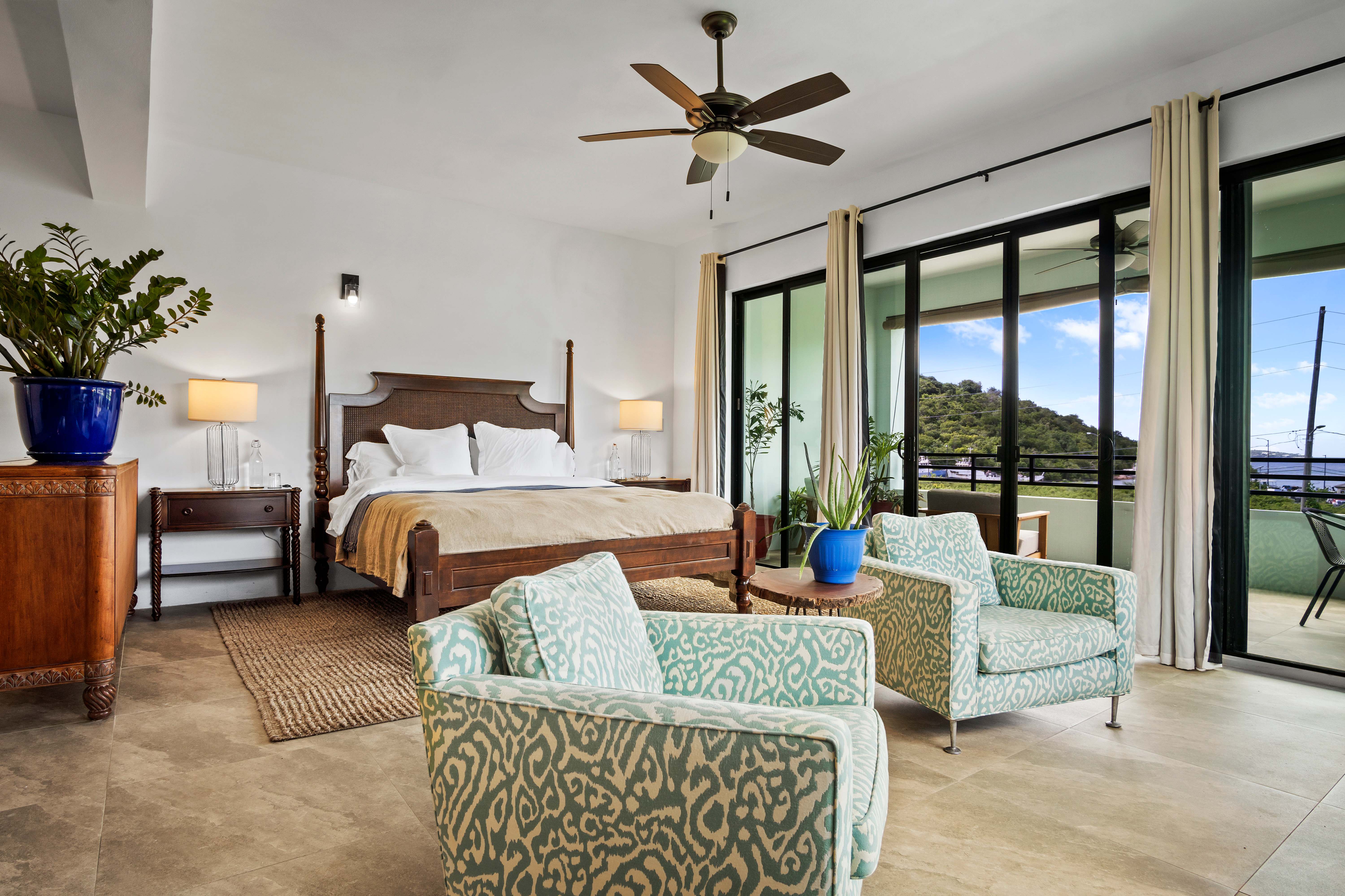 Spacious bedroom suite with four-poster bed and ocean views